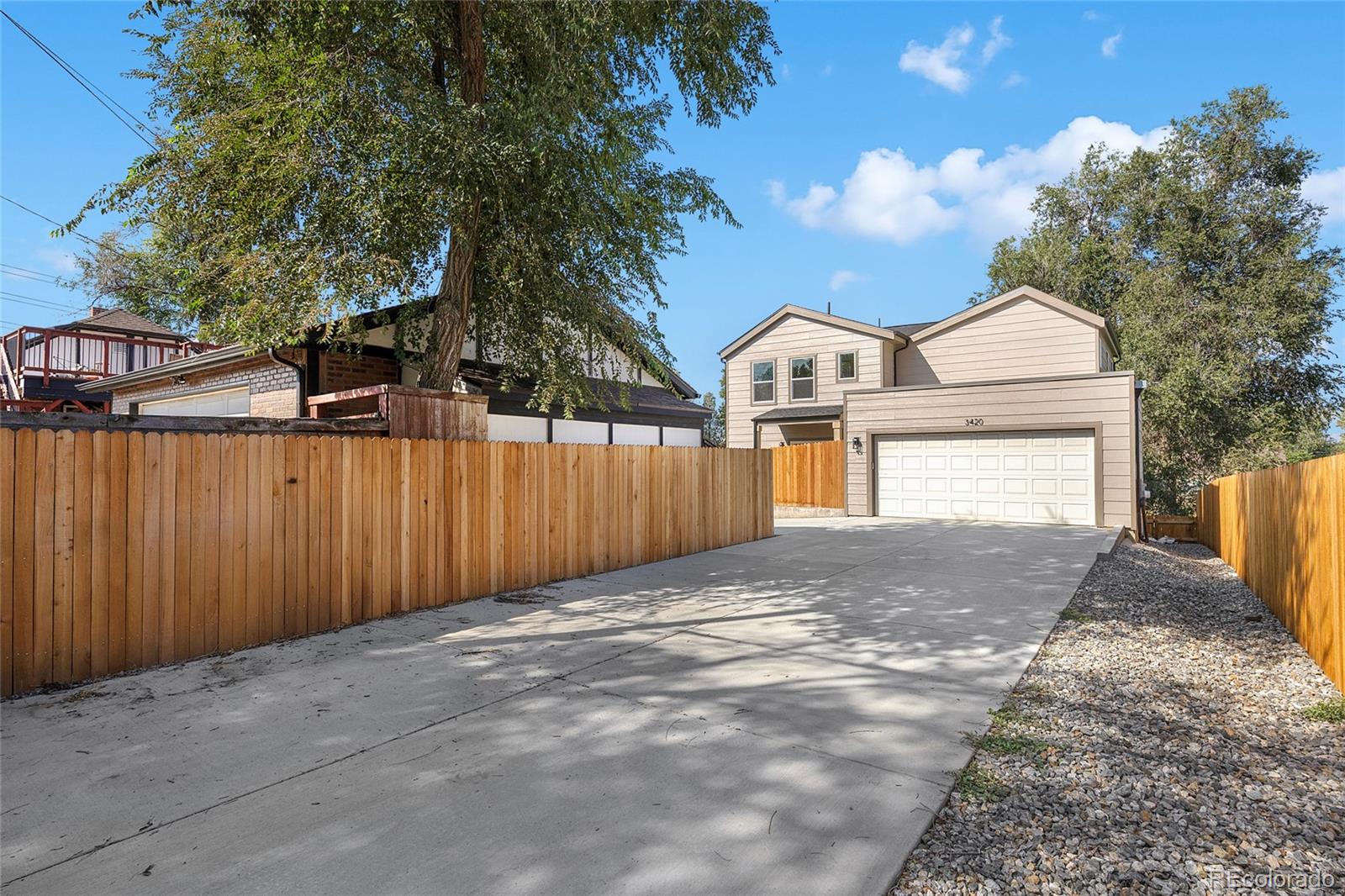 3420 Steele Street Denver, CO 80205 - Photo 40 of 50 a front view of a house with a yard and garage