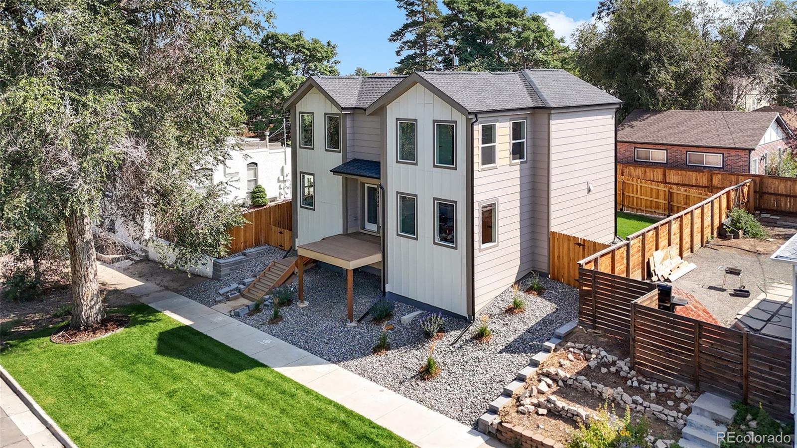 3420 Steele Street Denver, CO 80205 - Photo 44 of 50 a front view of a house with garden