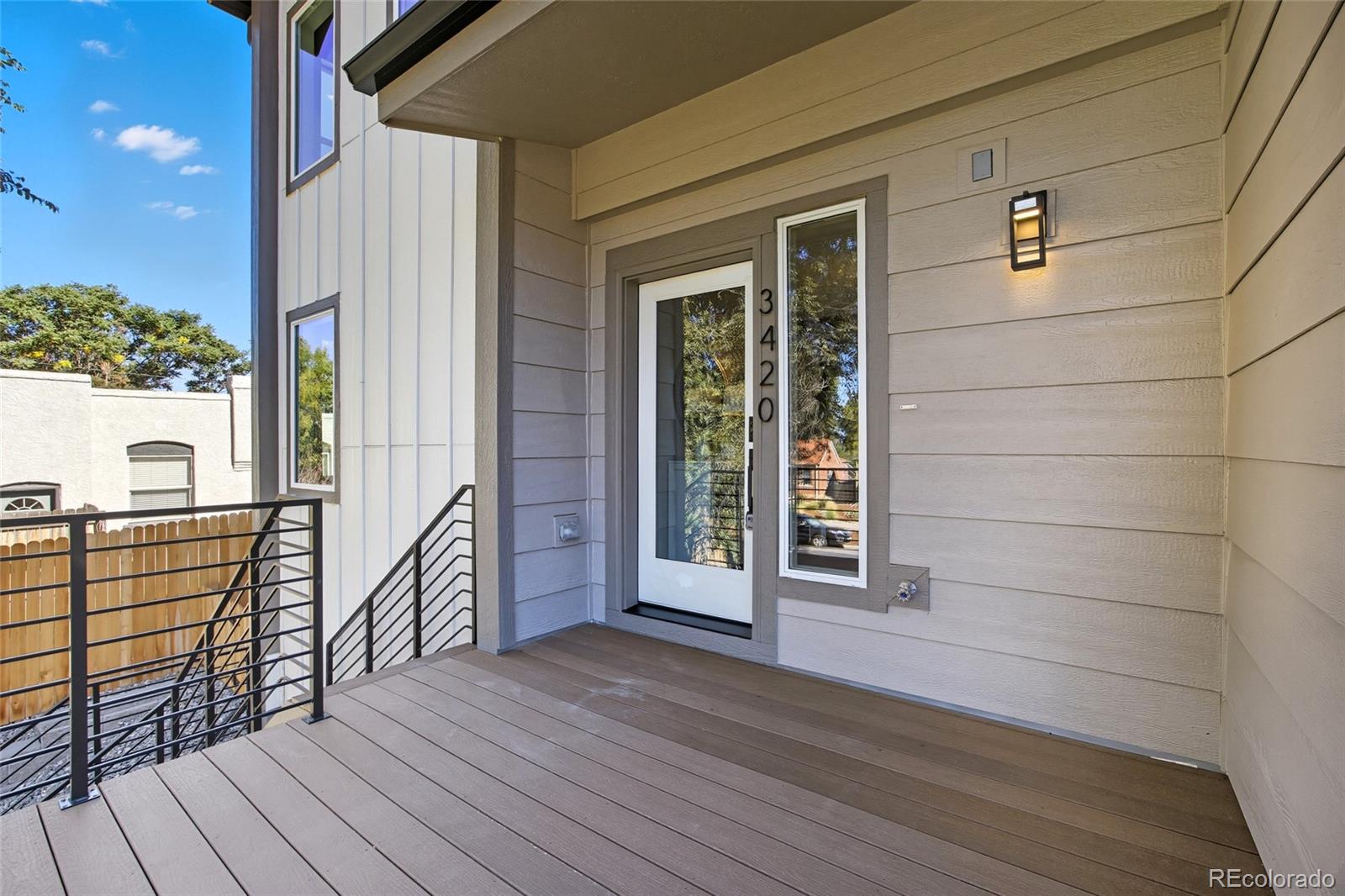 3420 Steele Street Denver, CO 80205 - Photo 6 of 50 a view of a balcony with wooden floor and iron stairs