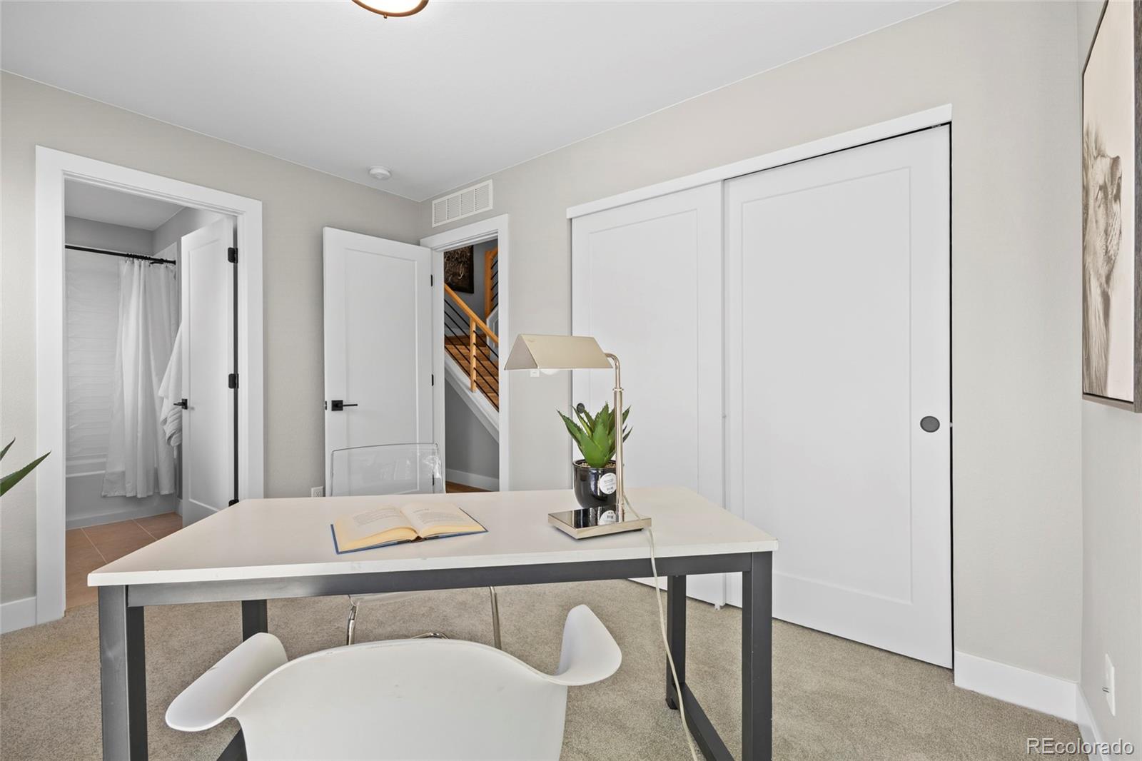 3420 Steele Street Denver, CO 80205 - Photo 10 of 50 a bathroom with a sink a mirror and a shower