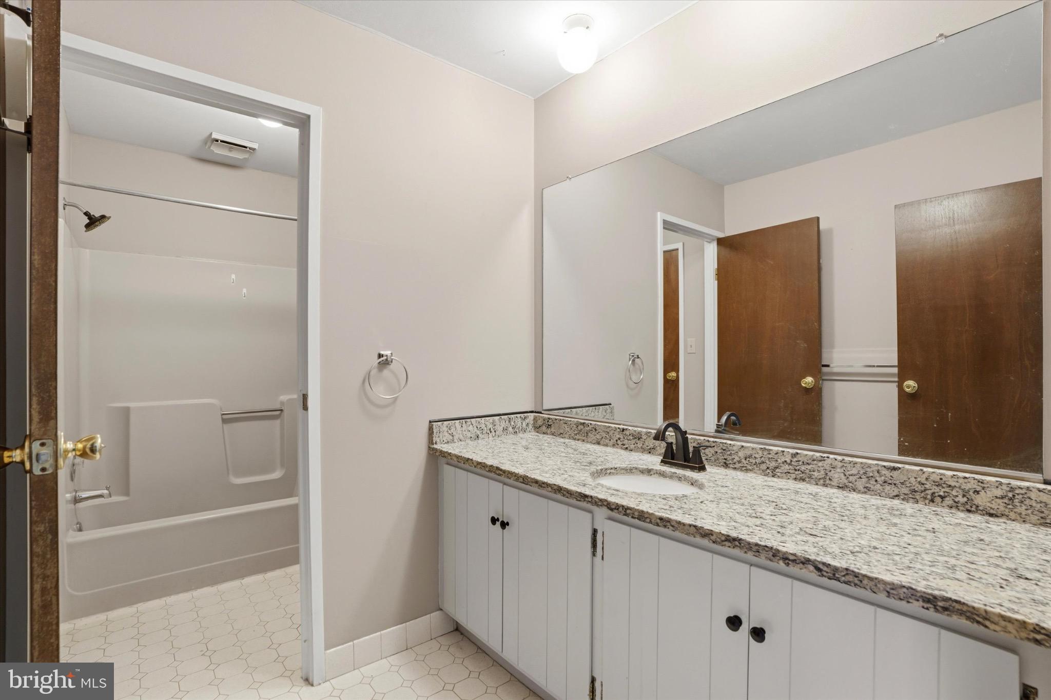 48 Muirfield Drive Reading, PA 19607 - Photo 10 of 15 a bathroom with a granite countertop sink and a mirror