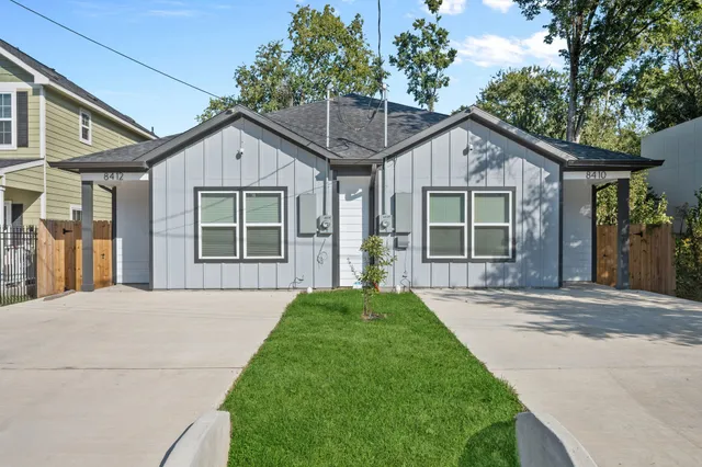 a view of a brick house with large windows