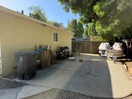 a view of a patio with table and chairs a barbeque and potted plants
