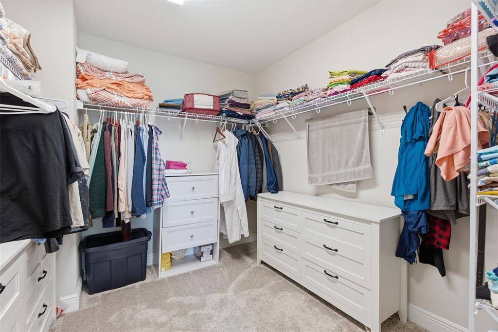 12970 Steed Trce Loop Lithia, FL 33547 - Photo 36 of 57 a view of walk in closet with clothes