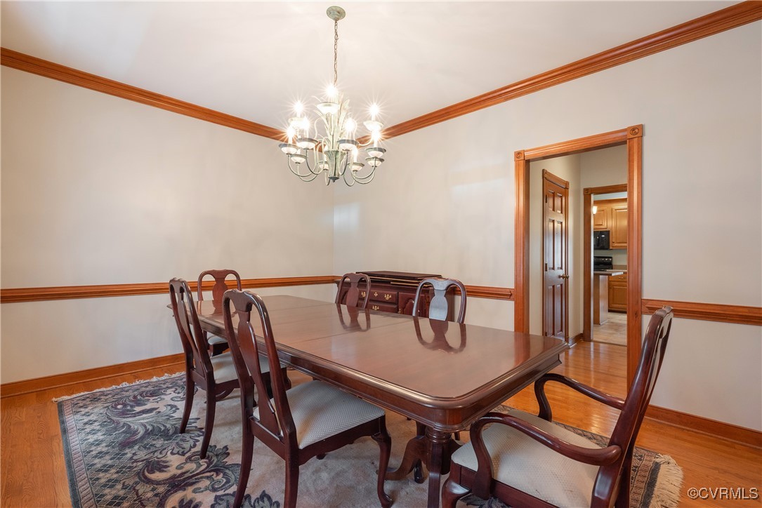 2770 Checketts Drive Sandy Hook, VA 23153 - Photo 14 of 50 a view of a dining room with furniture and chandelier