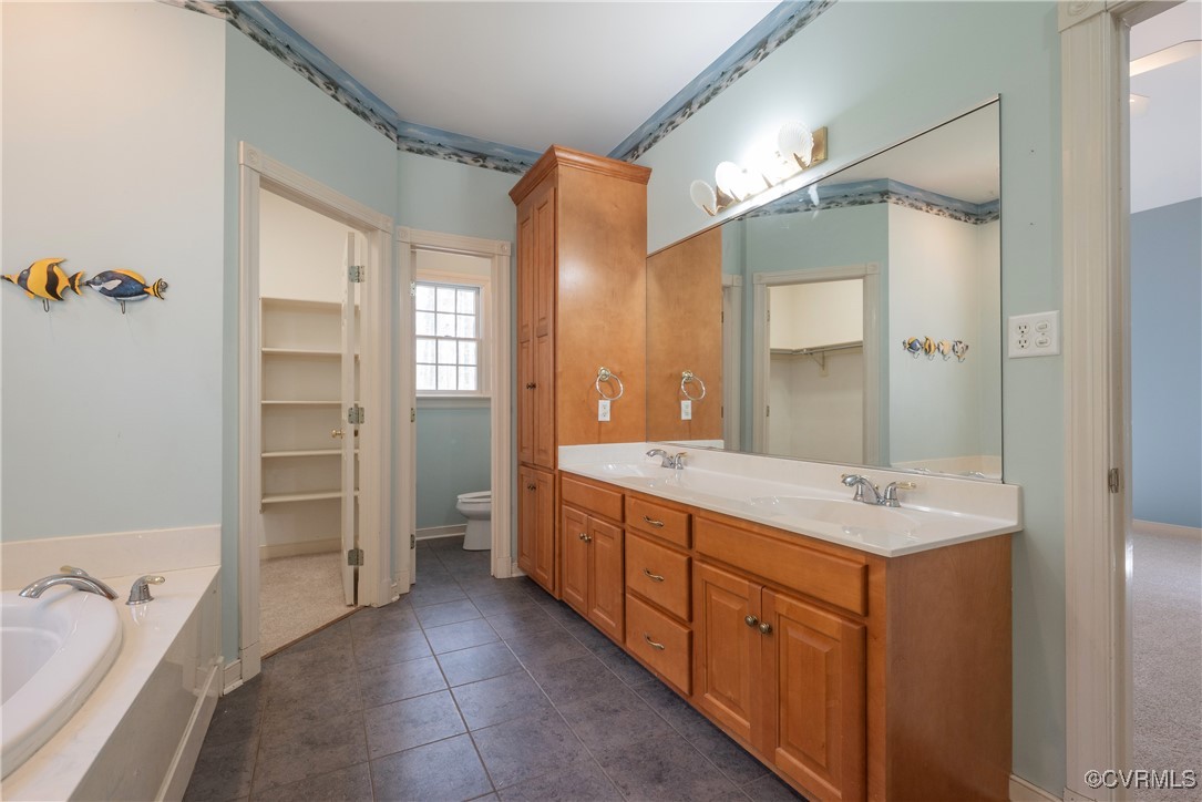 2770 Checketts Drive Sandy Hook, VA 23153 - Photo 30 of 50 a large bathroom with a double vanity sink a large mirror and a shower