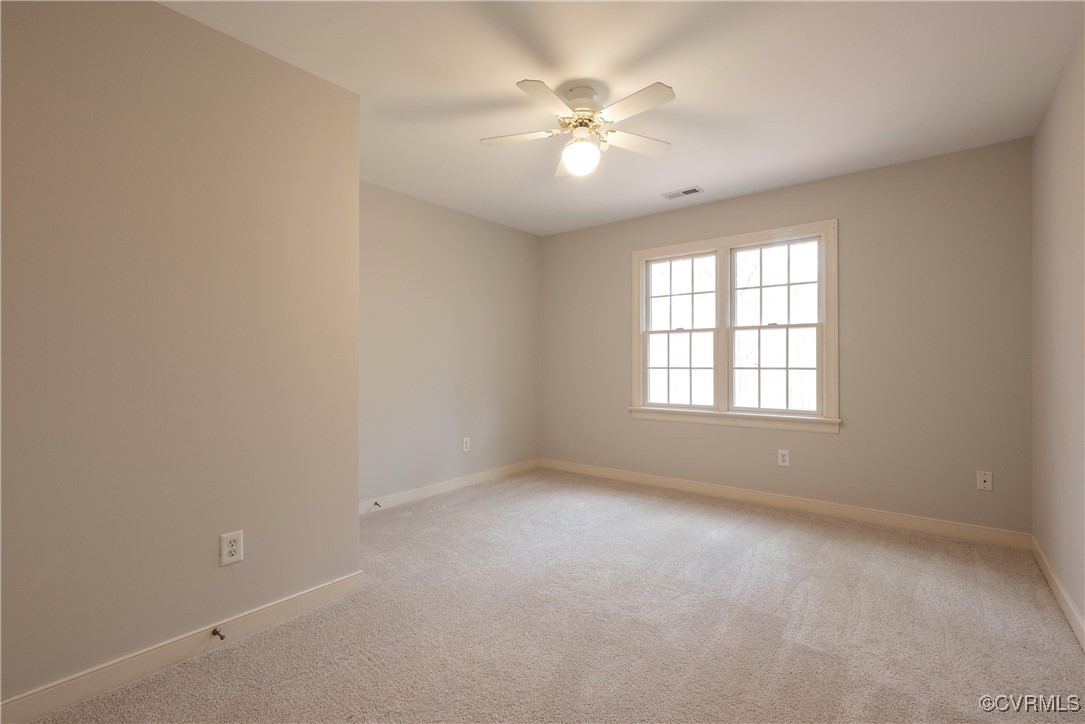 2770 Checketts Drive Sandy Hook, VA 23153 - Photo 40 of 50 an empty room with chandelier fan and windows