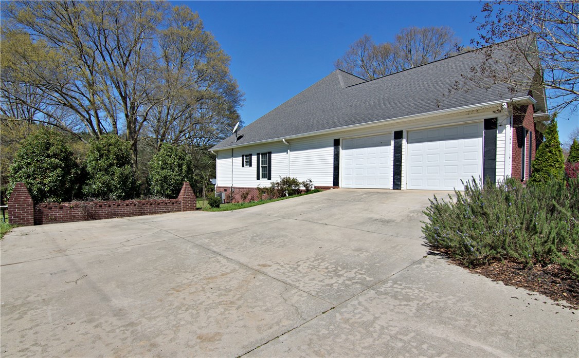 7893 Athens Road Carnesville, GA 30521 - Photo 2 of 50 This residence features a driveway leading to a convenient attached two-car garage.