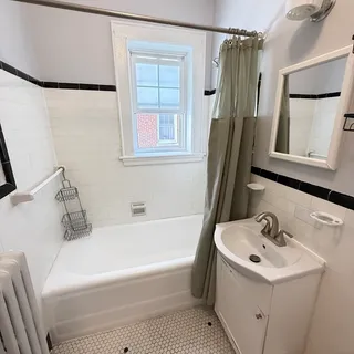 a bathroom with a sink a window and a mirror