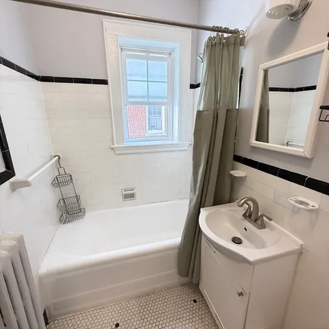 a bathroom with a sink a window and a mirror