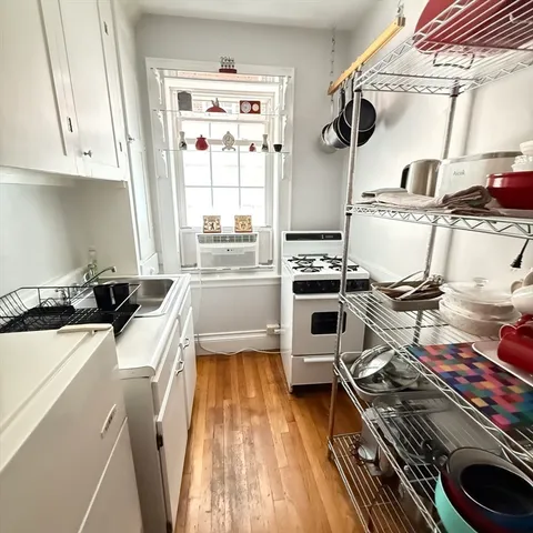 a kitchen with a stove a sink and a microwave
