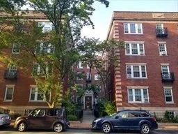 a front view of a building with trees