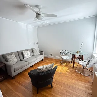 a living room with furniture and a pool table