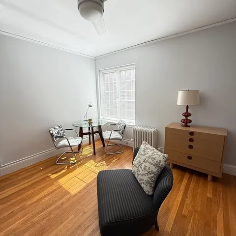 a bedroom with furniture and a window