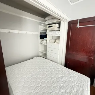 a bedroom with a bed and cabinets