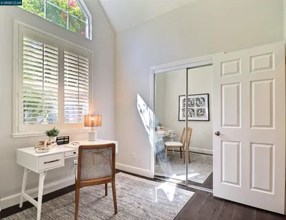 a view of a workspace with furniture and a window