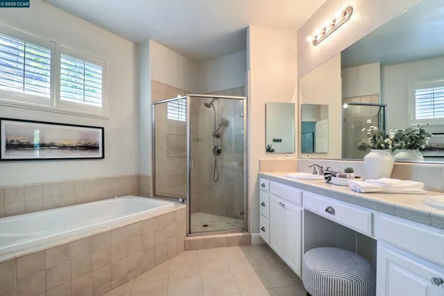 a bathroom with a granite countertop tub sink toilet and shower