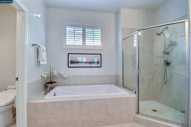 a white bath tub sitting next to a shower