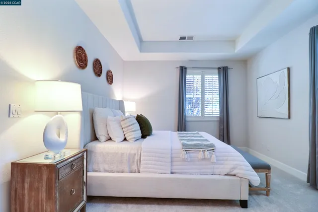 a bedroom with a bed and a lamp