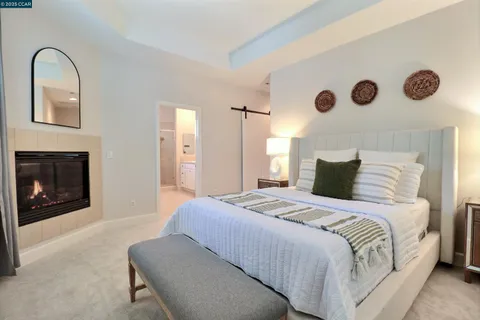 a bedroom with a bed and a fireplace