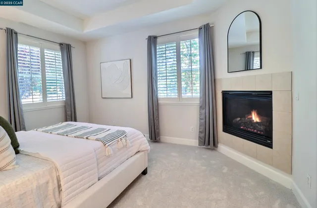 a bedroom with a bed and a fireplace