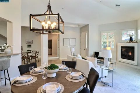 a dining room with furniture a chandelier and wooden floor