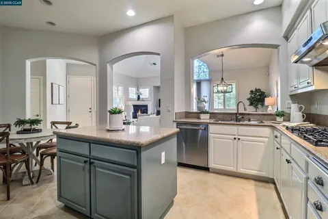 a kitchen with sink stove and cabinets