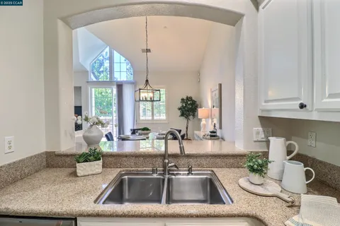 a kitchen with a sink and a chandelier