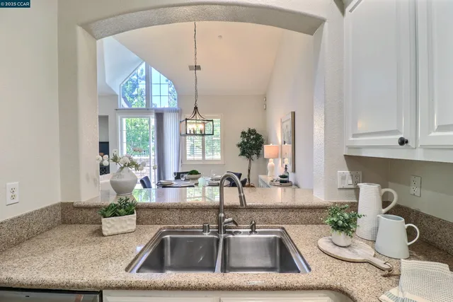 a kitchen with a sink and a chandelier