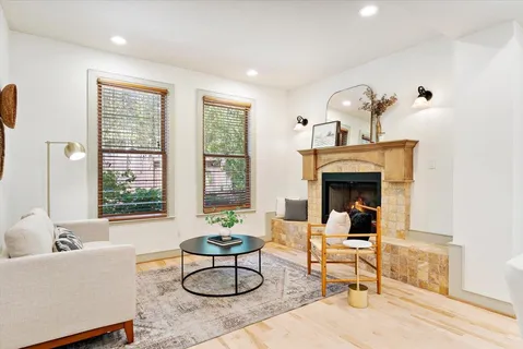 a living room with furniture and a fireplace