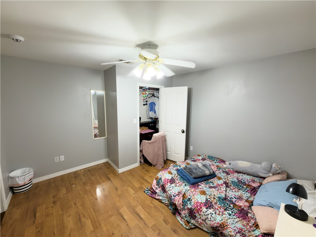 164 Park Road Russellville, AR 72802 - Photo 8 of 35 Room featuring wood-finish flooring, light gray walls, a ceiling fan with integrated lighting, and a white interior door