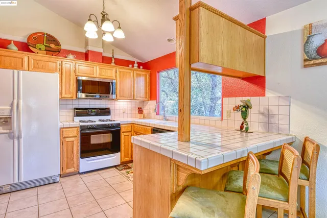 a kitchen with stainless steel appliances granite countertop a sink and a stove