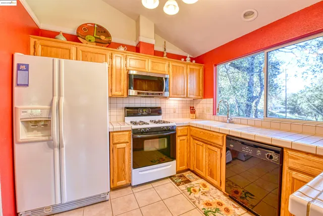 a kitchen with a sink a counter top space and cabinets