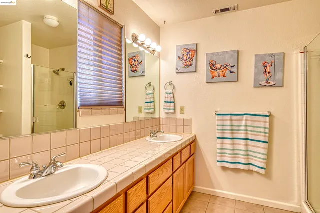 a spacious bathroom with a sink a mirror and a shower