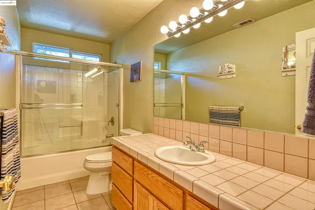 a bedroom with a bed and windows