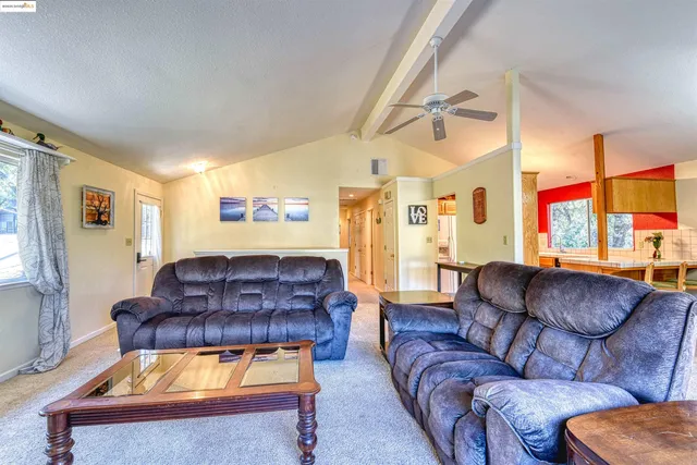 a living room with furniture a window and a flat screen tv