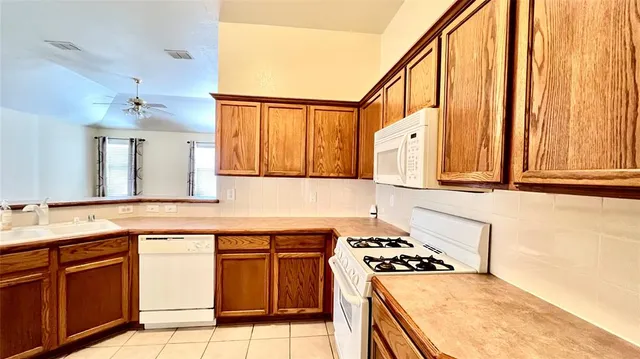 a view of a kitchen from the hallway