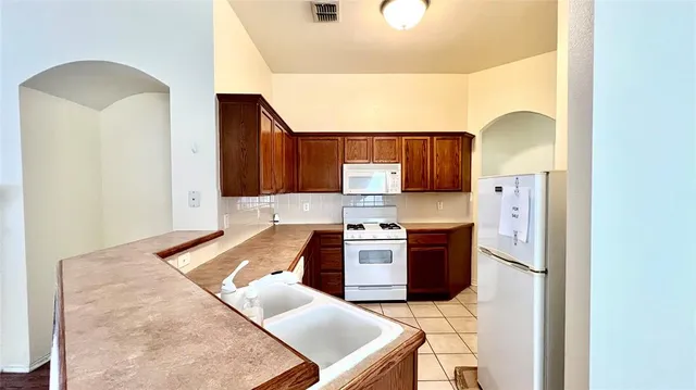 a kitchen with stainless steel appliances granite countertop a stove and a sink