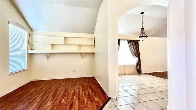 a view of a room with wooden floor and cabinet