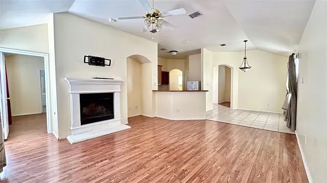 a view of a hallway with wooden floor and a fireplace
