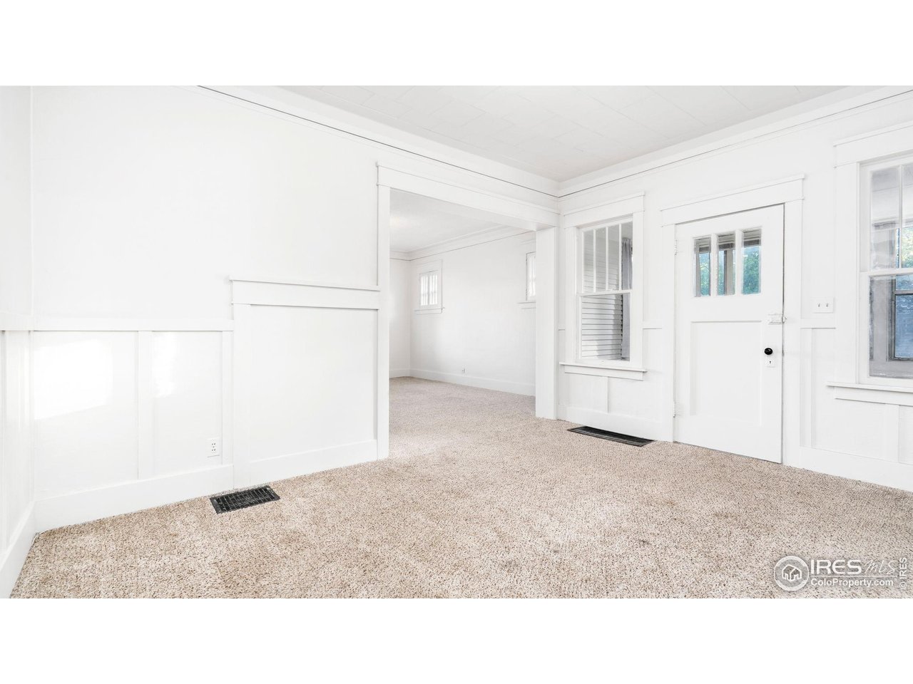 1029 Cranford Place Greeley, CO 80631 - Photo 18 of 34 a kitchen with white cabinets and refrigerator