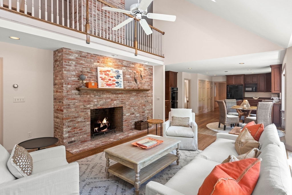 25 Dana Road Boxford, MA 01921 - Photo 14 of 41 a living room with furniture a fireplace and a flat screen tv