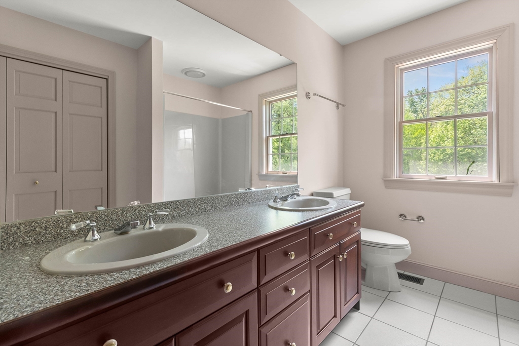 25 Dana Road Boxford, MA 01921 - Photo 30 of 41 a bathroom with a granite countertop sink a toilet a mirror and a window
