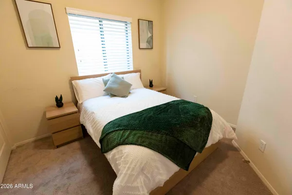 a bedroom with a bed and a window