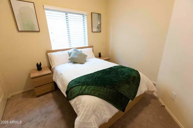 a bedroom with a bed and a window