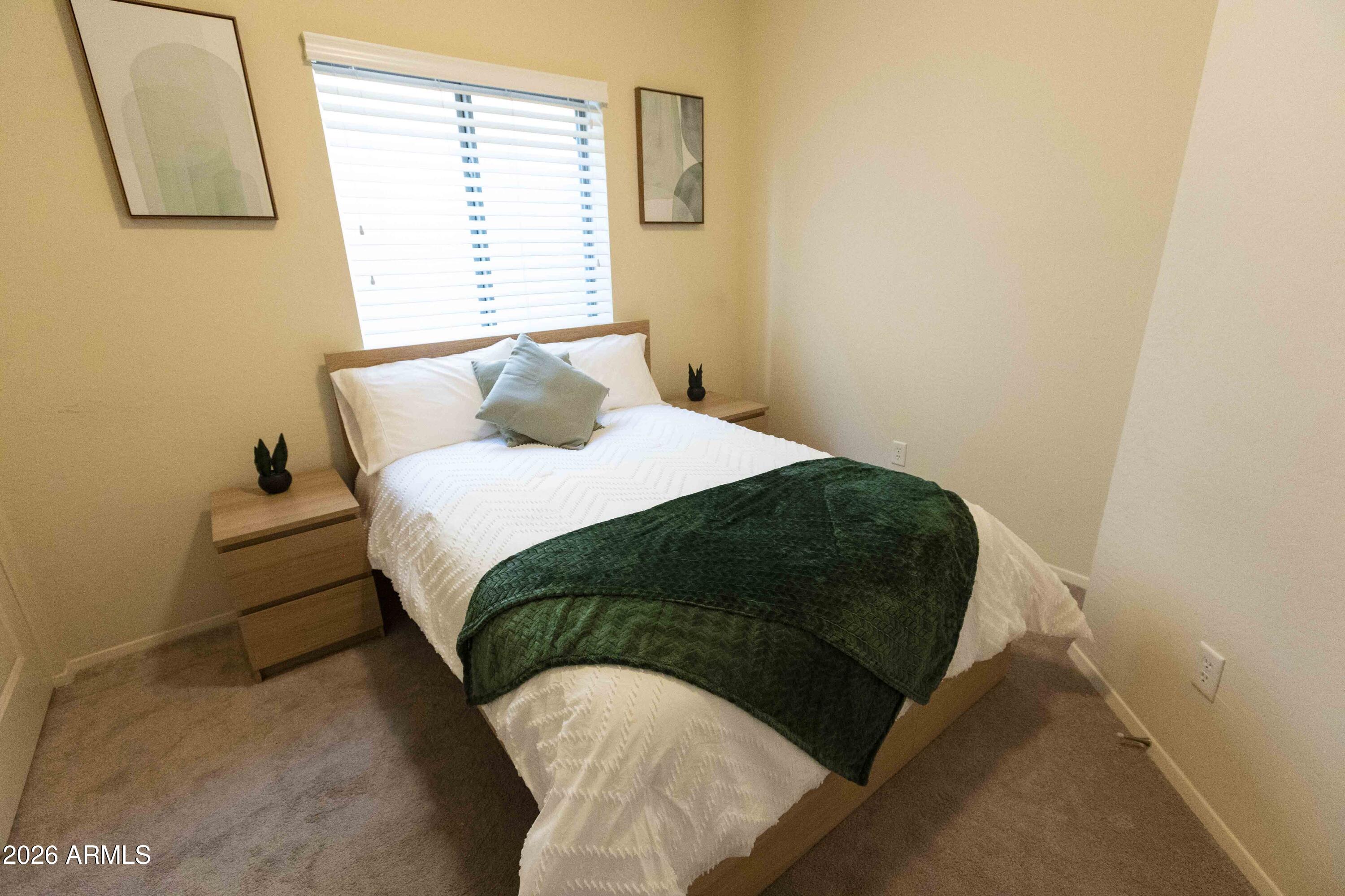 3113 East Danbury Road, Unit 22 Phoenix, AZ 85032 - Photo 12 of 17 a bedroom with a bed and a window