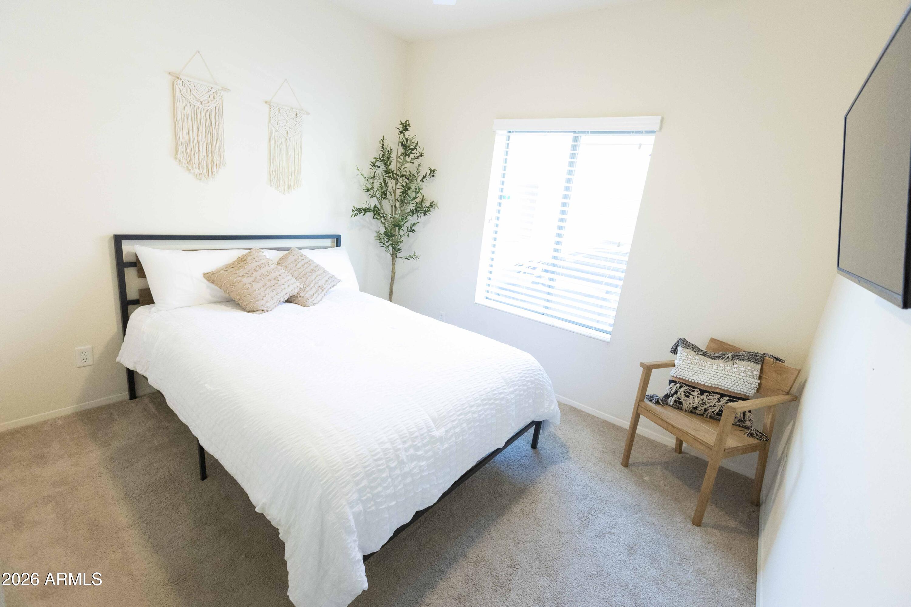 3113 East Danbury Road, Unit 22 Phoenix, AZ 85032 - Photo 14 of 17 a bedroom with a bed and a window