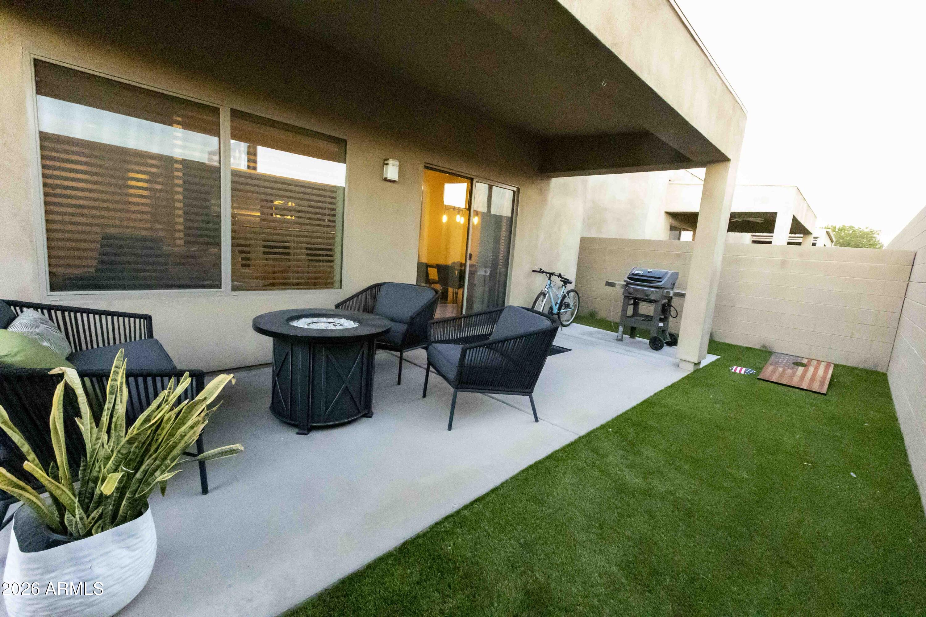 3113 East Danbury Road, Unit 22 Phoenix, AZ 85032 - Photo 16 of 17 a living room with patio furniture and a potted plant