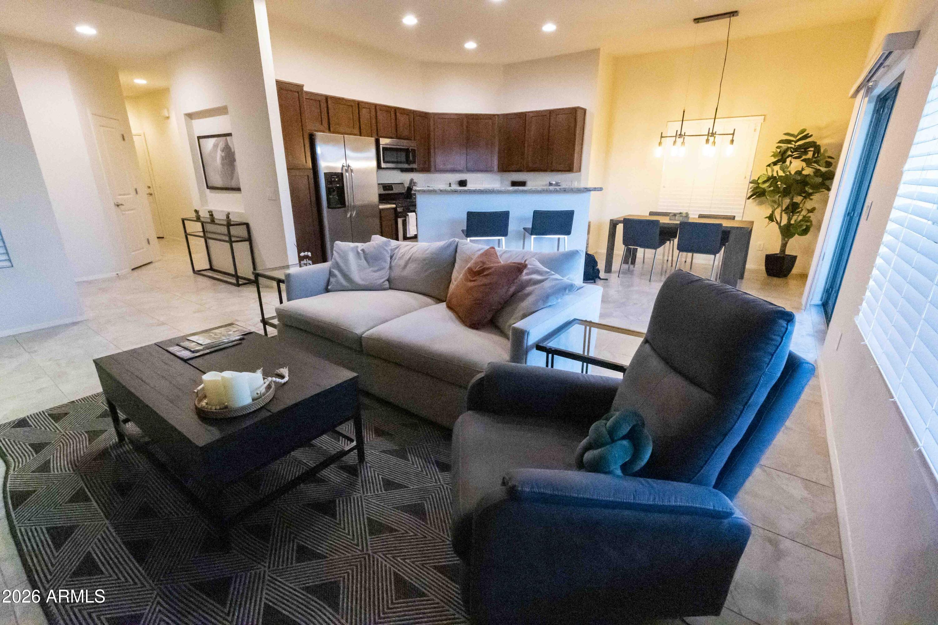 3113 East Danbury Road, Unit 22 Phoenix, AZ 85032 - Photo 5 of 17 a living room with furniture and a view of kitchen