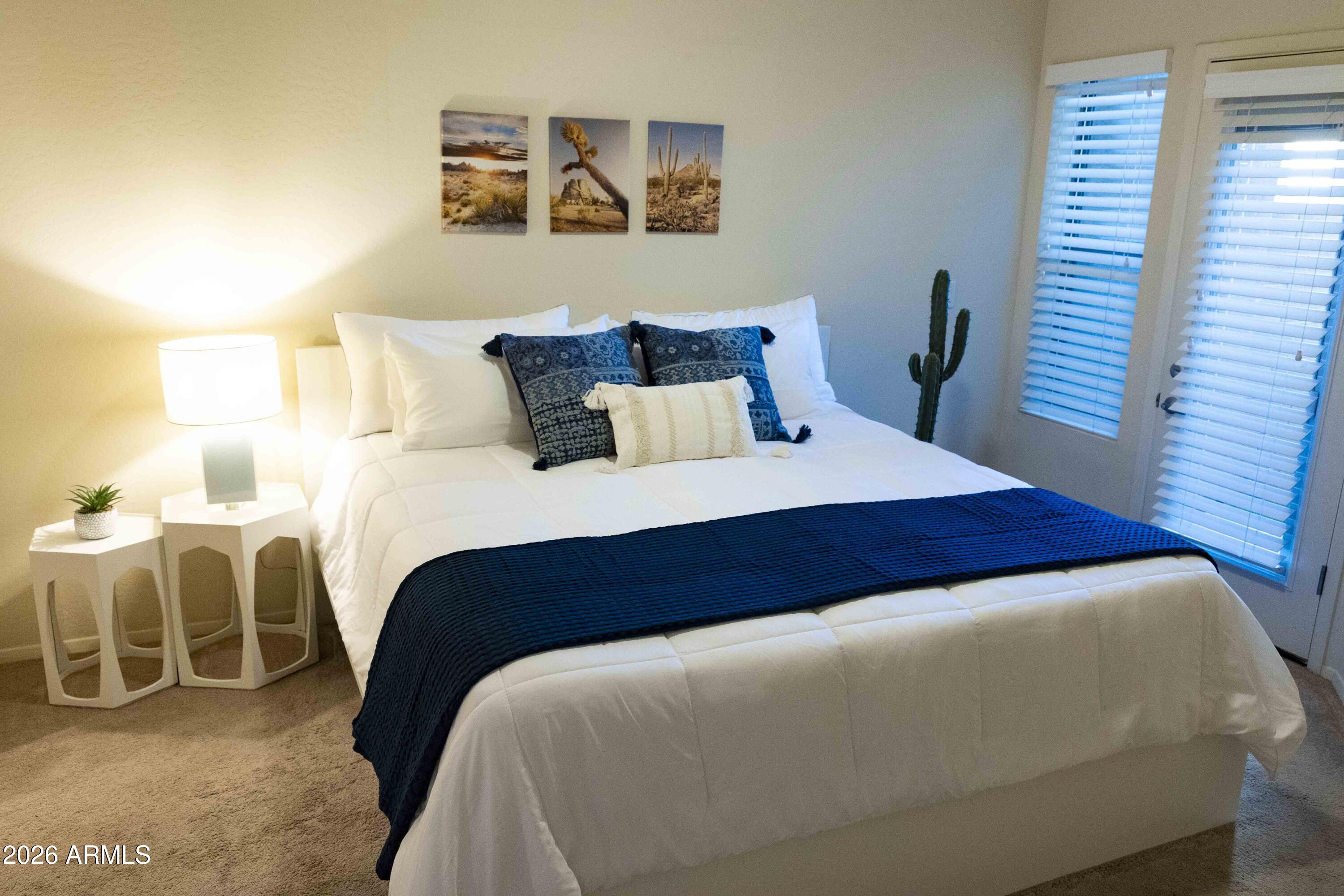 3113 East Danbury Road, Unit 22 Phoenix, AZ 85032 - Photo 9 of 17 a bedroom with a bed and chair